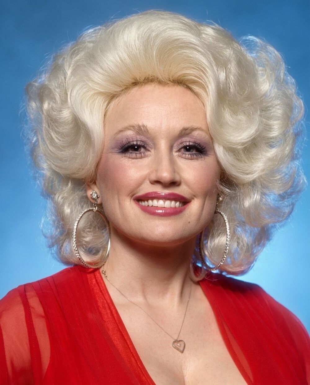 Dolly Parton 8x10” Photograph Reprint Dolly in Red With Blue Background